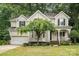 Charming home with a well-maintained lawn, mature trees, and inviting curb appeal in a peaceful, wooded setting at 8256 Chatham Oaks Dr, Concord, NC 28027