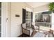 Inviting front porch with comfortable seating, decorative accents, and a view of the home's exterior at 8256 Chatham Oaks Dr, Concord, NC 28027