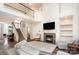 Bright living room with fireplace, high ceilings, and staircase leading to the second floor in a naturally lit space at 8256 Chatham Oaks Dr, Concord, NC 28027