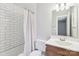 Well-lit bathroom featuring subway tile surround and updated vanity at 8510 Castle Pine Ct, Charlotte, NC 28226
