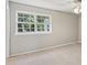Bright bedroom featuring a large window offering natural light and neutral carpeting at 8510 Castle Pine Ct, Charlotte, NC 28226