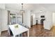 Open dining area with hardwood floors adjacent to a modern kitchen with stainless steel appliances at 8510 Castle Pine Ct, Charlotte, NC 28226