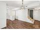 Refinished hardwood floors connect the dining area to a staircase, enhancing open floor plan at 8510 Castle Pine Ct, Charlotte, NC 28226