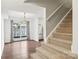 Carpeted stairs adjacent to the dining area, features hardwood floors with an open floor plan at 8510 Castle Pine Ct, Charlotte, NC 28226