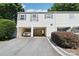 Townhome exterior featuring attached garages, neutral siding, and well-maintained landscaping at 8510 Castle Pine Ct, Charlotte, NC 28226