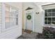 Welcoming front entrance featuring a white door with wreath accent and sidelight windows at 8510 Castle Pine Ct, Charlotte, NC 28226