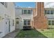 Inviting townhouse featuring a well-maintained lawn and a charming brick chimney at 8510 Castle Pine Ct, Charlotte, NC 28226