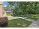 Lush front yard with mature trees and landscaping enhances the property's curb appeal at 8510 Castle Pine Ct, Charlotte, NC 28226