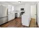 Bright kitchen features white cabinets, stainless steel appliances, and wood floors at 8510 Castle Pine Ct, Charlotte, NC 28226