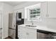 Updated kitchen with stainless steel appliances, white cabinets, and natural light at 8510 Castle Pine Ct, Charlotte, NC 28226