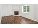 Bright and airy living room featuring refinished hardwood floors and a cozy fireplace at 8510 Castle Pine Ct, Charlotte, NC 28226