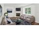 Bright living room features a fireplace, ample seating, and natural light from the window at 8510 Castle Pine Ct, Charlotte, NC 28226