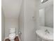 Compact half bathroom features a white toilet and sink with a chrome faucet, maximizing space at 8524 Emerald Fern Way, Charlotte, NC 28214