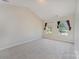 Spacious bedroom with plush carpeting and two windows, providing plenty of natural light at 8524 Emerald Fern Way, Charlotte, NC 28214