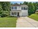 Charming two-story home with a welcoming front porch and well-maintained landscaping and long driveway at 8524 Emerald Fern Way, Charlotte, NC 28214