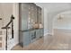 Custom bar area features cabinetry, a sink, and a wine fridge for entertaining guests at 8721 Lake Challis Ln, Charlotte, NC 28226