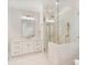 Bathroom featuring a walk-in shower, vanity with gold hardware, and white tiled floors at 8721 Lake Challis Ln, Charlotte, NC 28226