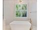 Bathroom features a soaking tub, a window with shutters, and brushed gold hardware at 8721 Lake Challis Ln, Charlotte, NC 28226