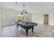 Entertaining space with a pool table, pendant lighting, and natural light at 8721 Lake Challis Ln, Charlotte, NC 28226