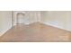 Large bonus room features hardwood floors and ample space with lots of natural light at 8721 Lake Challis Ln, Charlotte, NC 28226