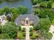 Stunning waterfront estate boasts manicured landscaping and a stately facade with lake views at 8721 Lake Challis Ln, Charlotte, NC 28226