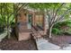 Charming brick home with a small front porch and mature landscaping at 8721 Lake Challis Ln, Charlotte, NC 28226