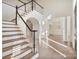 Elegant foyer features a grand staircase, soaring ceilings, and abundant natural light at 8721 Lake Challis Ln, Charlotte, NC 28226