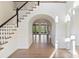 Bright open foyer with hardwood floors leads to living spaces with elegant archways and natural light at 8721 Lake Challis Ln, Charlotte, NC 28226