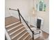 Grand foyer featuring a soaring window, chandelier, and elegant staircase with wood treads and white risers at 8721 Lake Challis Ln, Charlotte, NC 28226