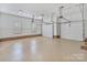 Spacious three-car garage with epoxy floors and ample storage space at 8721 Lake Challis Ln, Charlotte, NC 28226