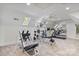 Home gym featuring skylights, mirrors, and plenty of space for workout equipment at 8721 Lake Challis Ln, Charlotte, NC 28226