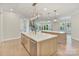 Open kitchen design with double islands leading to rooms in background including stairway at 8721 Lake Challis Ln, Charlotte, NC 28226