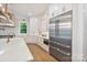 Beautiful gourmet kitchen with stainless steel refrigerator and island with large countertop at 8721 Lake Challis Ln, Charlotte, NC 28226