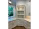 Bright kitchen features custom white cabinetry, quartz countertops, and a view of the surrounding landscape at 8721 Lake Challis Ln, Charlotte, NC 28226