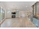Open-concept living room with a fireplace, built-in bar, and views into the gourmet kitchen at 8721 Lake Challis Ln, Charlotte, NC 28226