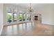Bright living room boasts hardwood floors, chandelier, and access to an outdoor patio with lake views at 8721 Lake Challis Ln, Charlotte, NC 28226