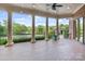 Spacious brick patio with pillars overlooking landscaped yard, gazebo and distant water views at 8721 Lake Challis Ln, Charlotte, NC 28226