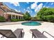 Outdoor living includes a spacious pool area with travertine tile and lounge chairs, ideal for entertaining at 8721 Lake Challis Ln, Charlotte, NC 28226