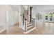 Elegant staircase with wood treads, white risers, and black handrails connects the levels of the home at 8721 Lake Challis Ln, Charlotte, NC 28226