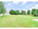 Expansive backyard featuring lawn, trees, and blue sky at 9641 Bellamy Nw Pl, Concord, NC 28027