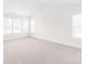 Bright bedroom featuring neutral carpet, three windows, and ample natural light at 9641 Bellamy Nw Pl, Concord, NC 28027
