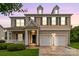 Charming two-story home features a manicured lawn, two-car garage, and inviting front porch at 9641 Bellamy Nw Pl, Concord, NC 28027