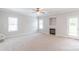 Spacious living room has neutral decor, a cozy fireplace, and ample natural light at 9641 Bellamy Nw Pl, Concord, NC 28027