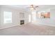 Bright and airy living room with fireplace flows seamlessly into the eat-in kitchen at 9641 Bellamy Nw Pl, Concord, NC 28027