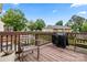 Spacious back deck with a grill and seating with views of the surrounding trees at 9651 Bailey Rd, Cornelius, NC 28031