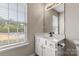 Well lit bathroom features a sink and vanity with a large window providing natural light at 9651 Bailey Rd, Cornelius, NC 28031