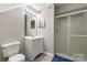 Clean bathroom with a shower, vanity, and well-lit mirror at 9651 Bailey Rd, Cornelius, NC 28031
