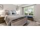 Inviting bedroom with a comfy bed, bench, and a large bright window at 9651 Bailey Rd, Cornelius, NC 28031