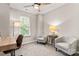 Bedroom boasts a cozy sitting area with two chairs, a desk and large window at 9651 Bailey Rd, Cornelius, NC 28031