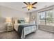 Inviting bedroom with ceiling fan, large window, and comfortable furnishings at 9651 Bailey Rd, Cornelius, NC 28031